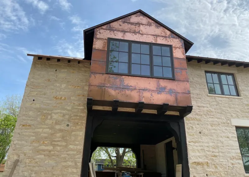 Copper metal panel facade on a stone building for Roof Repair in Spring Valley